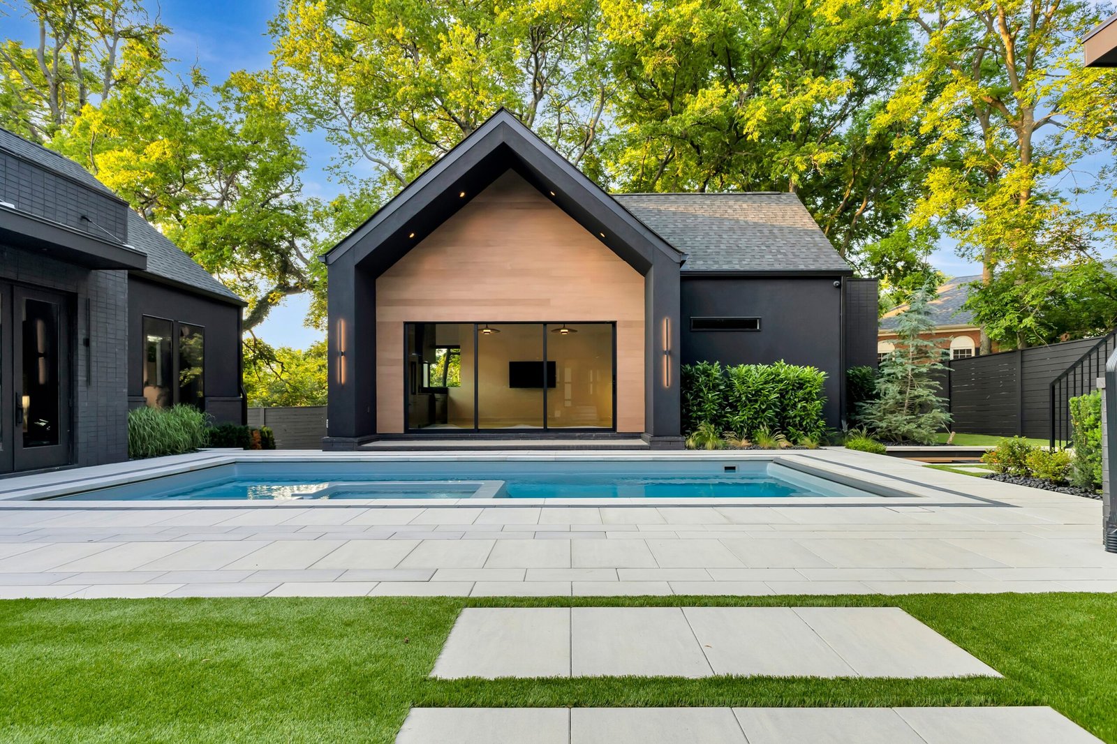 Custom pool builder in Nashville designing a modern backyard oasis with a luxury in-ground pool and outdoor living space.