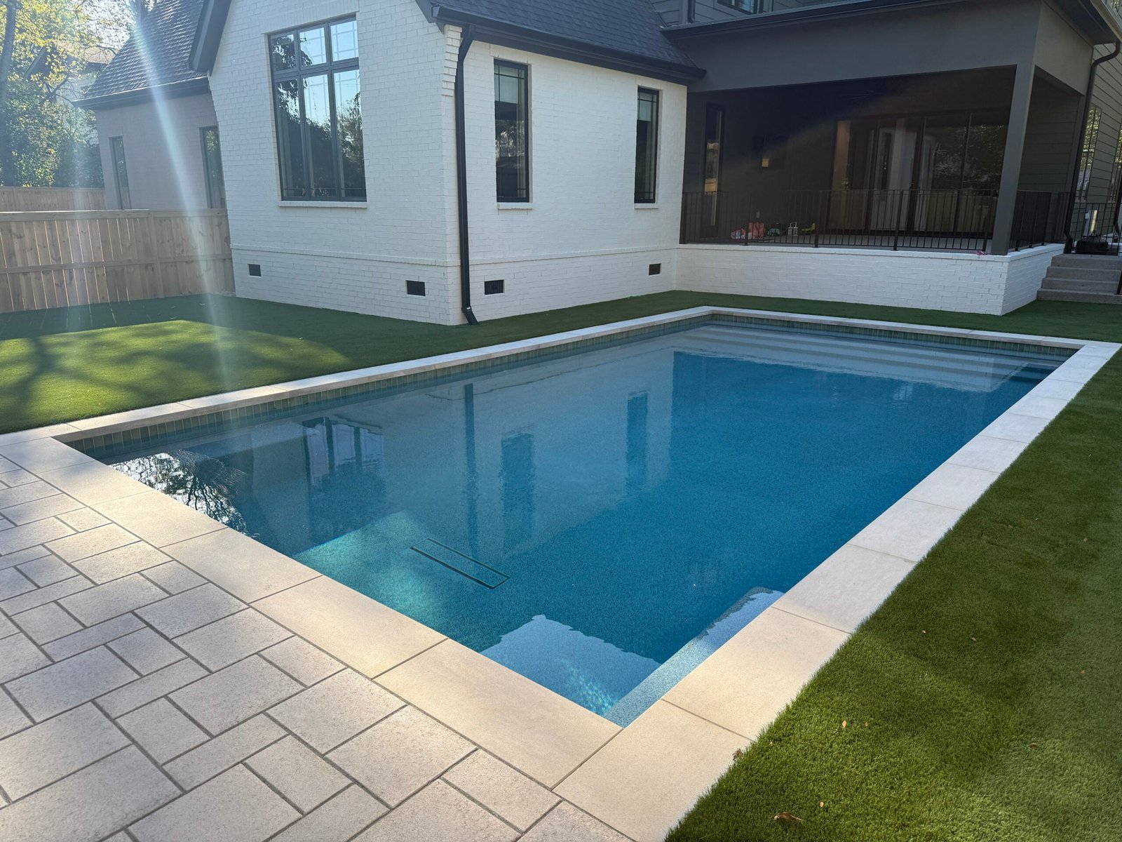 Custom vinyl swimming pool by Denali Pools & Outdoors with luxury backyard design
