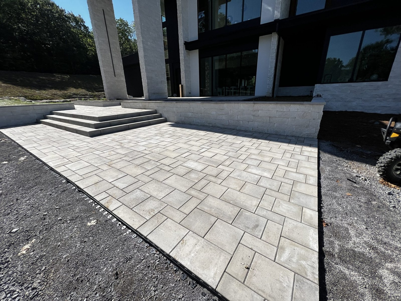 Elegant custom front patio with stone pavers and modern landscaping by Denali Pools & Outdoors in Nashville, TN